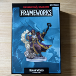 Dungeons & Dragons Frameworks Human Wizard Miniature by Wizkids in its packaging, featuring the figure in a dynamic pose with a spell effect and a pug companion.