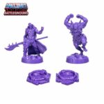 Unpainted purple plastic Scareglow and Beast Man miniatures with two portal terrain pieces.